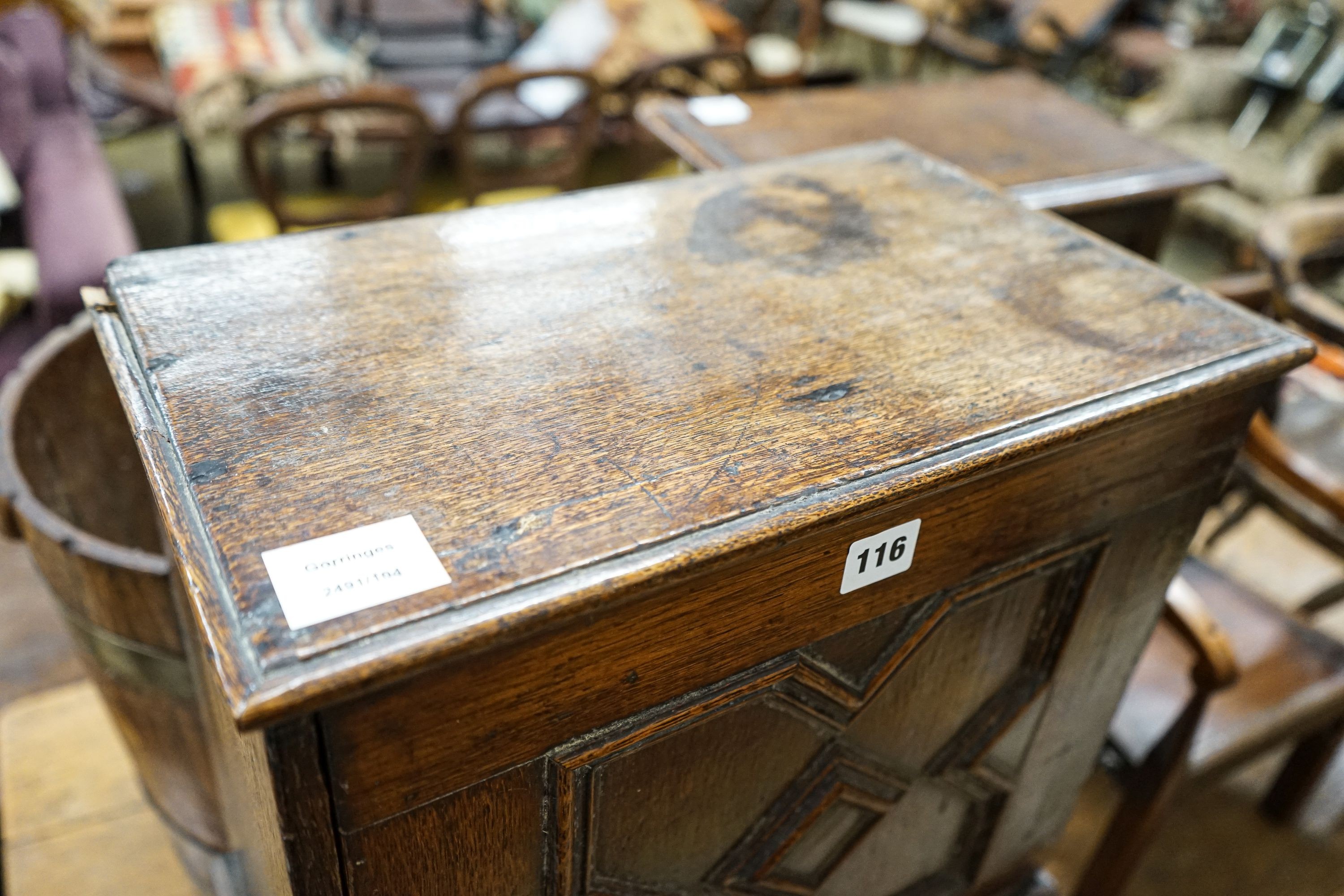 A late 17th century oak spice cupboard, with geometric panelled door enclosing five small drawers, on later stand, width 43cm, depth 27cm, height 67cm